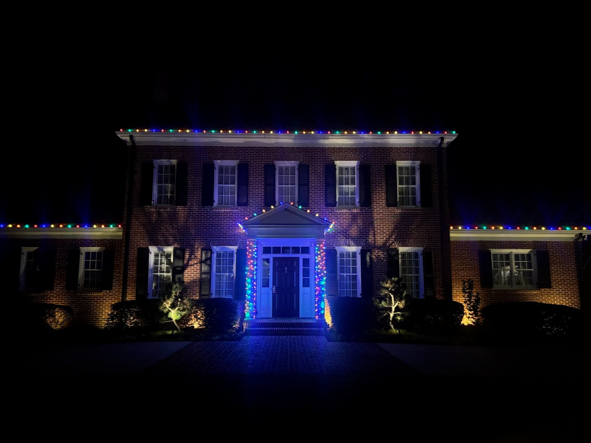 Multicolor Holiday Light Installation for a Brick Home image